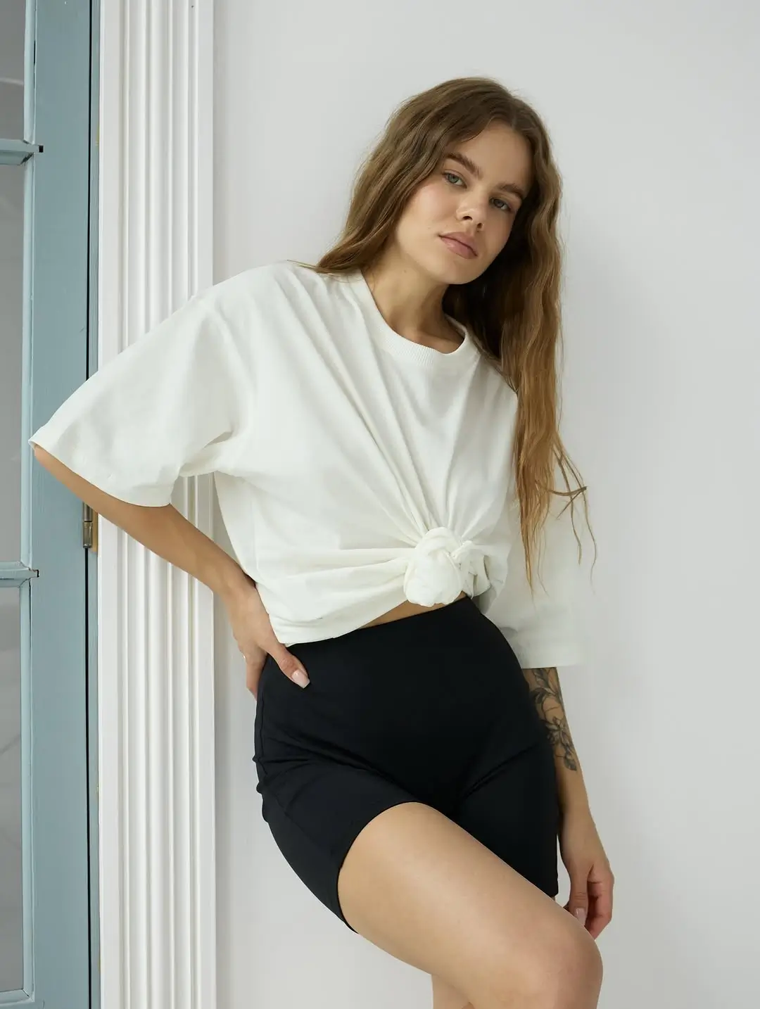 biker shorts outfits summer 2026 White Tee Knot Styling with Classic Black Shorts