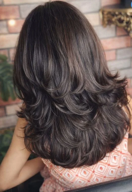 face-framing summer butterfly haircut 2026 Chocolate Feathered Layers That Flip and Flow
