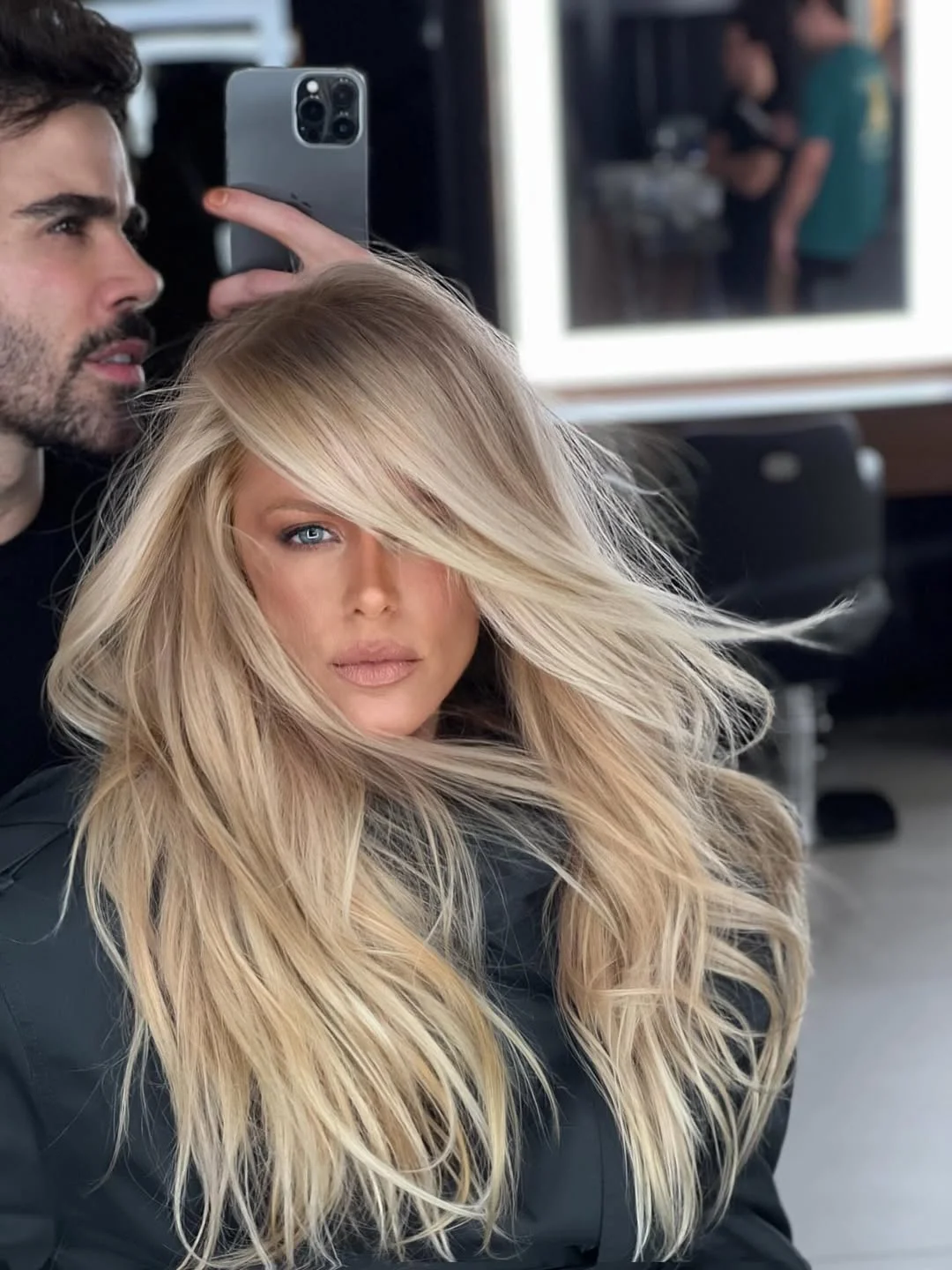 face-framing summer haircuts with bangs 2026 Voluminous Blonde Layers with Side Swept Bangs