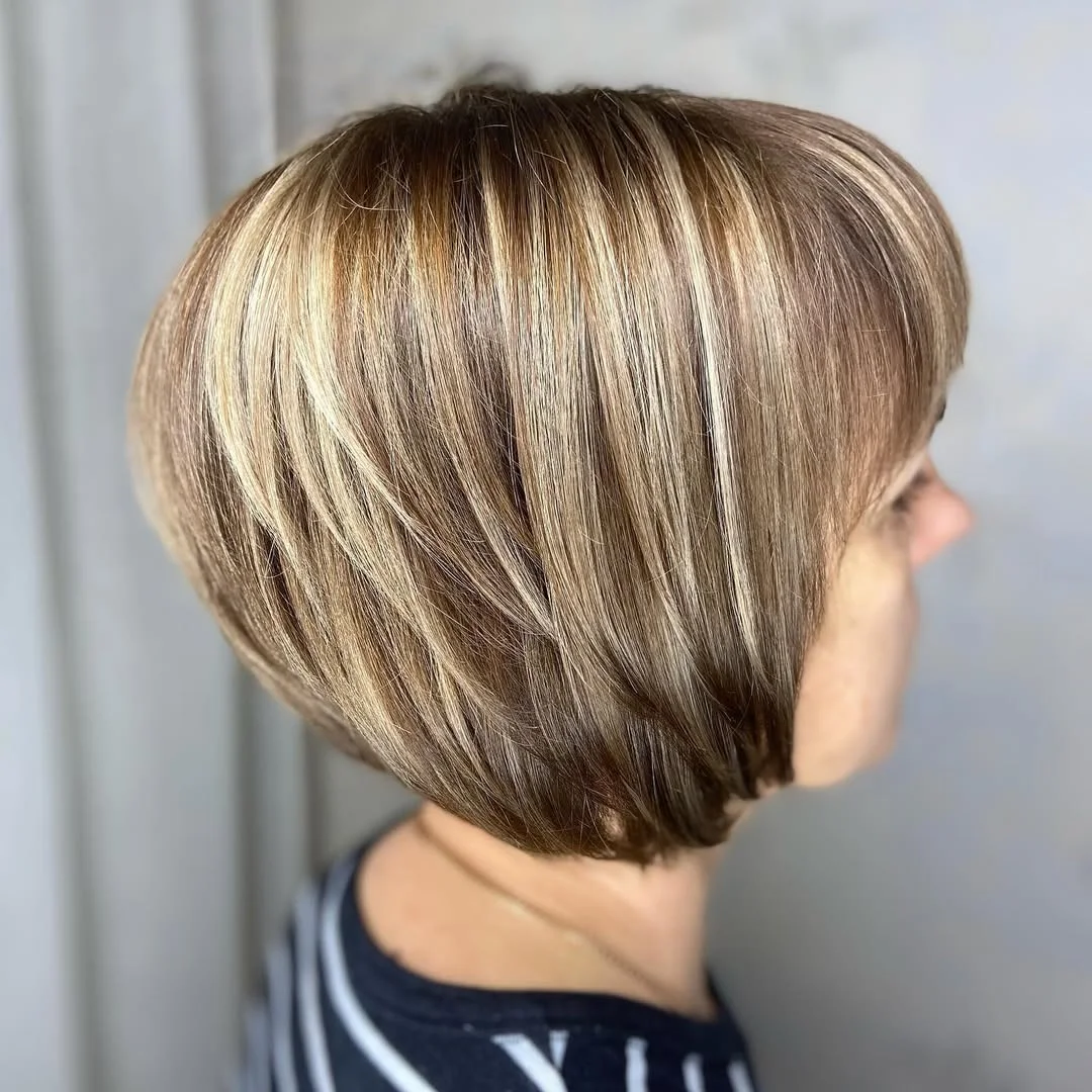 flattering summer haircuts for women over 50 2026 Soft Highlighted Stacked Bob with Dimension