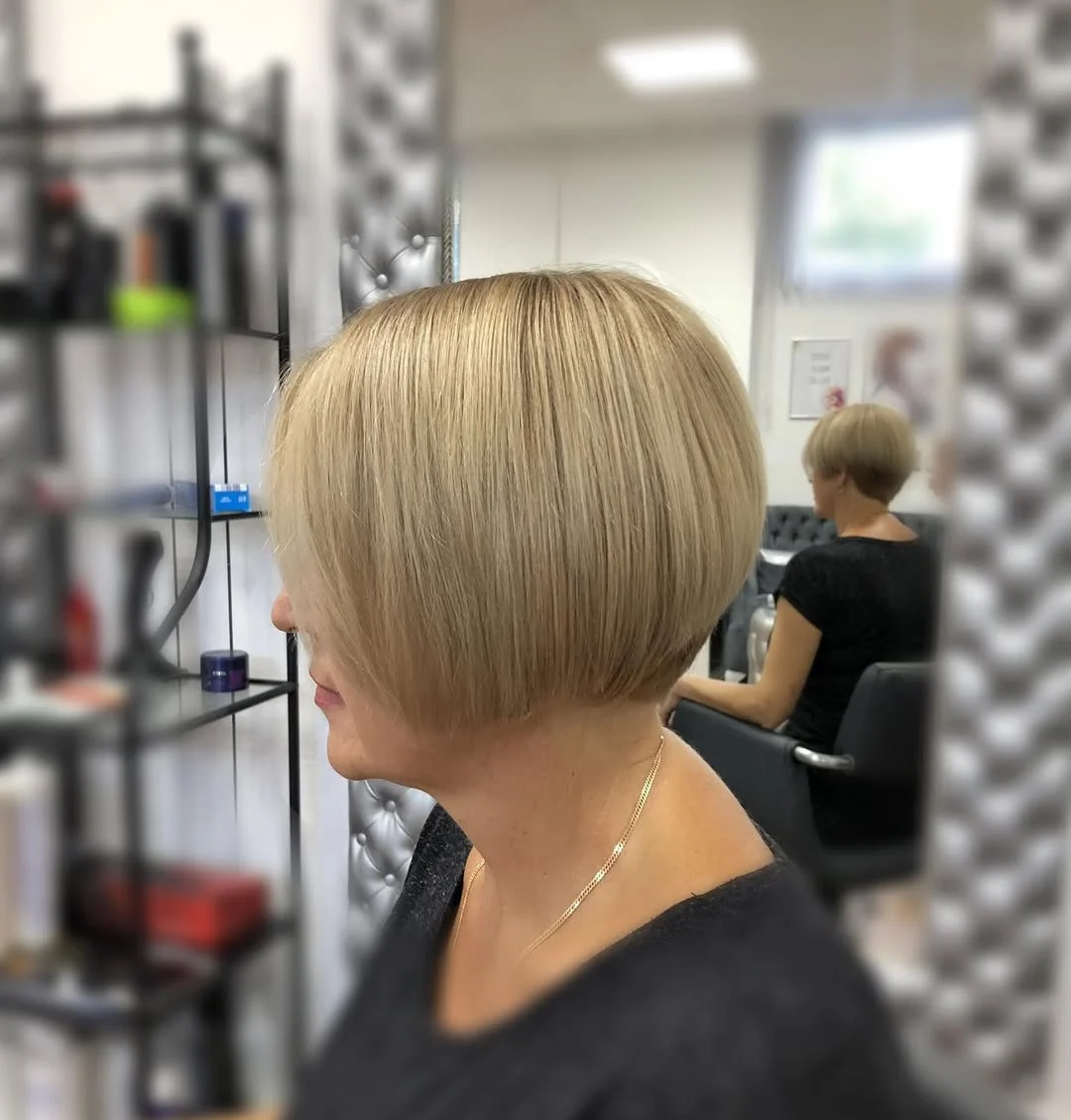 flattering summer haircuts for women over 50 2026 Stacked Volume Bob With a Modern Edge