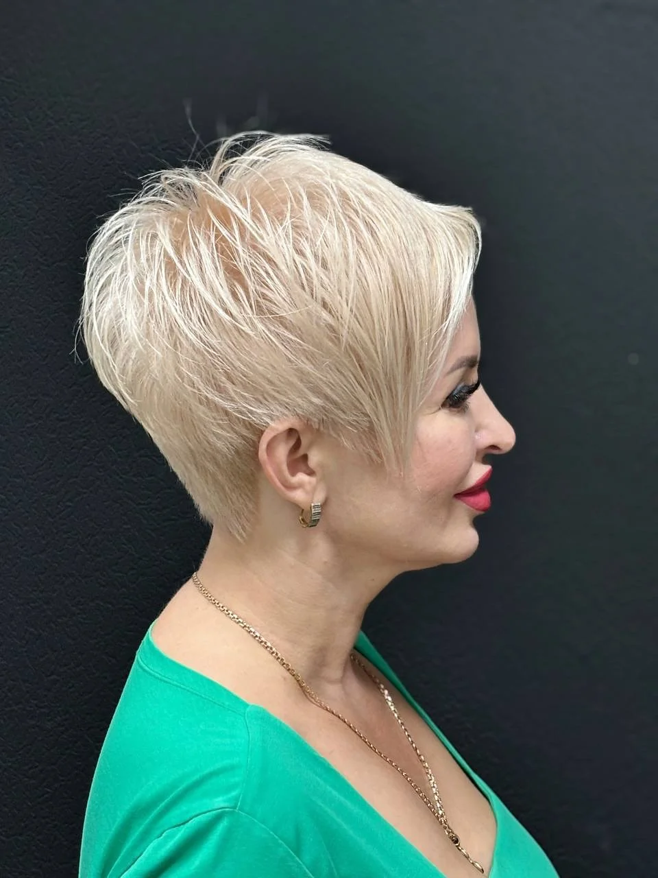 flattering summer haircuts for women over 50 2026 Feathered Blonde Pixie with Volume