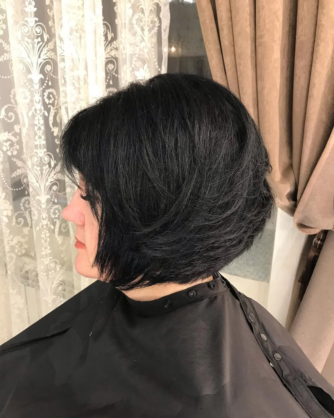 flattering summer haircuts for women over 50 2026 Soft Black Layered Bob with Volume