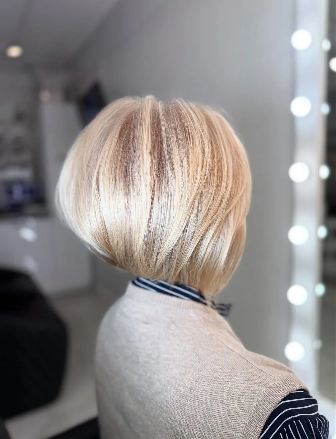 flattering summer haircuts for women over 60 2026 Bright Blonde Stacked Bob with Airy Layers