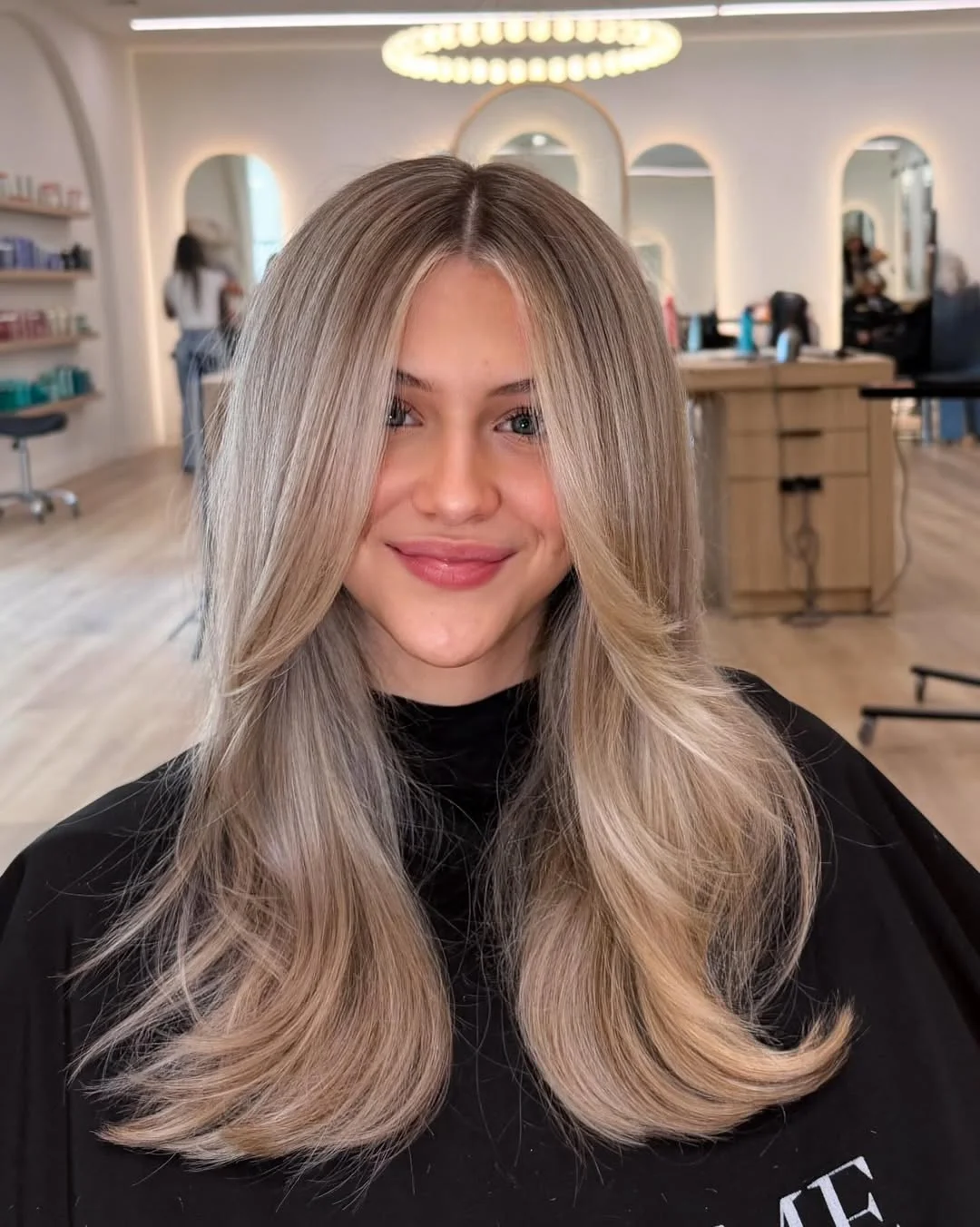 layered summer haircuts for fuller faces 2026 Mid Length Blowout Layers With Curtain Flow