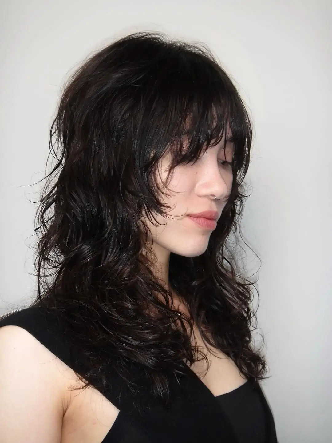 layered summer shag haircut 2026 Curly shag with textured fringe attitude