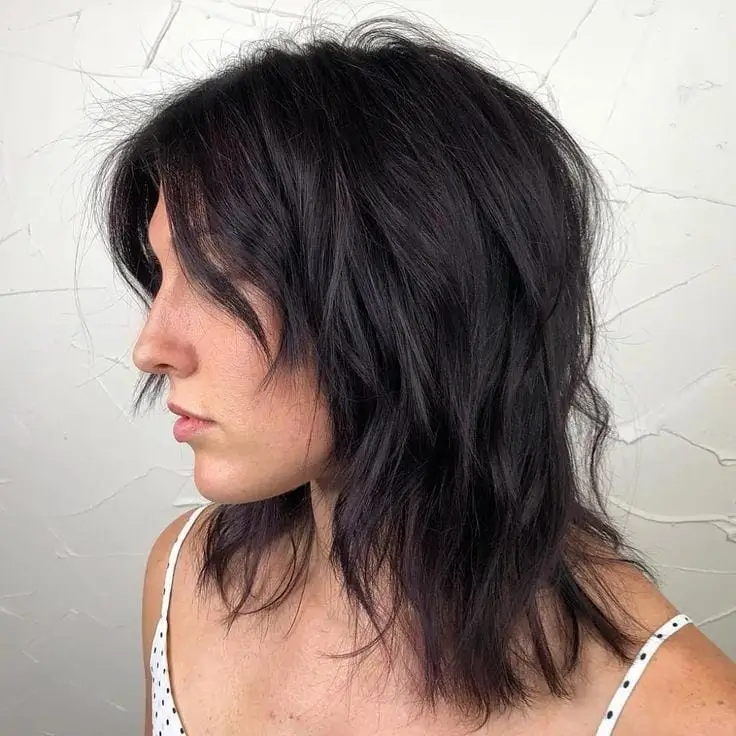 layered summer shag haircut 2026 Mid length shag with subtle volume waves