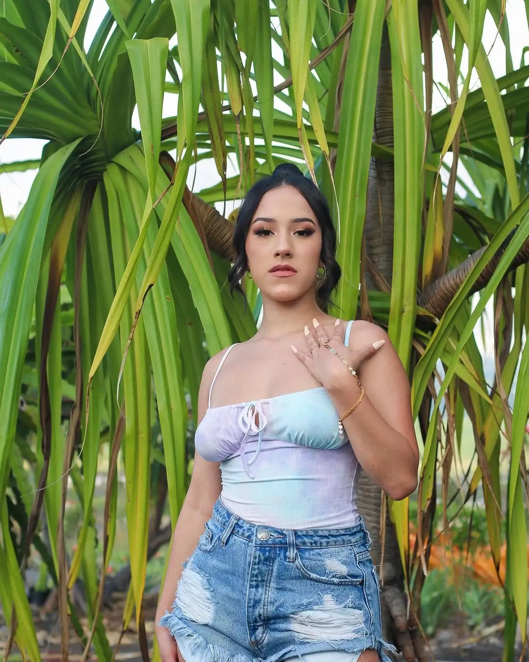 summer bodysuit outfits for women 2026 Romantic pastel bodysuit paired with distressed denim ease