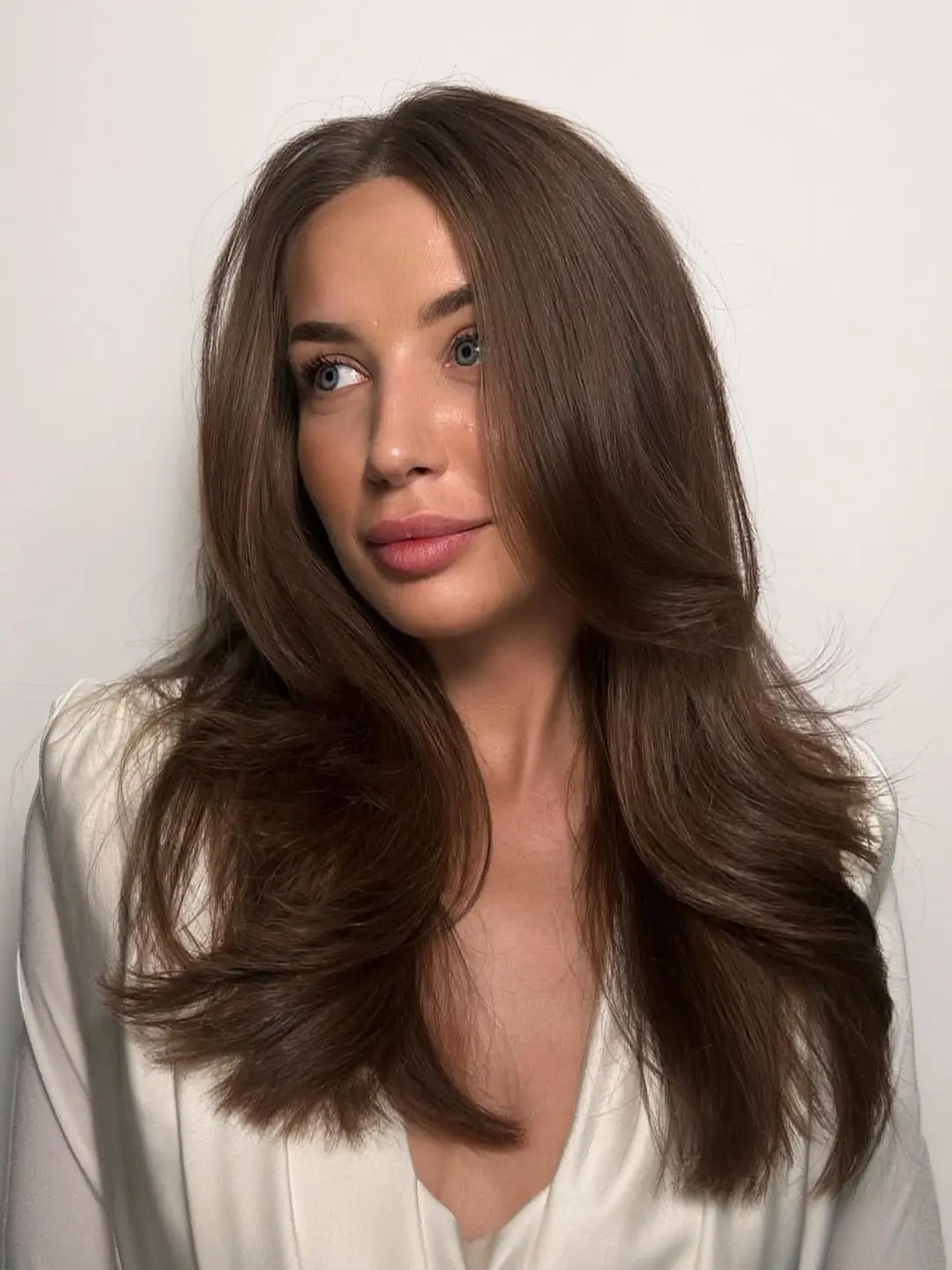 textured summer haircuts for long hair 2026 Voluminous Blowout Layers with Subtle Flicked Ends