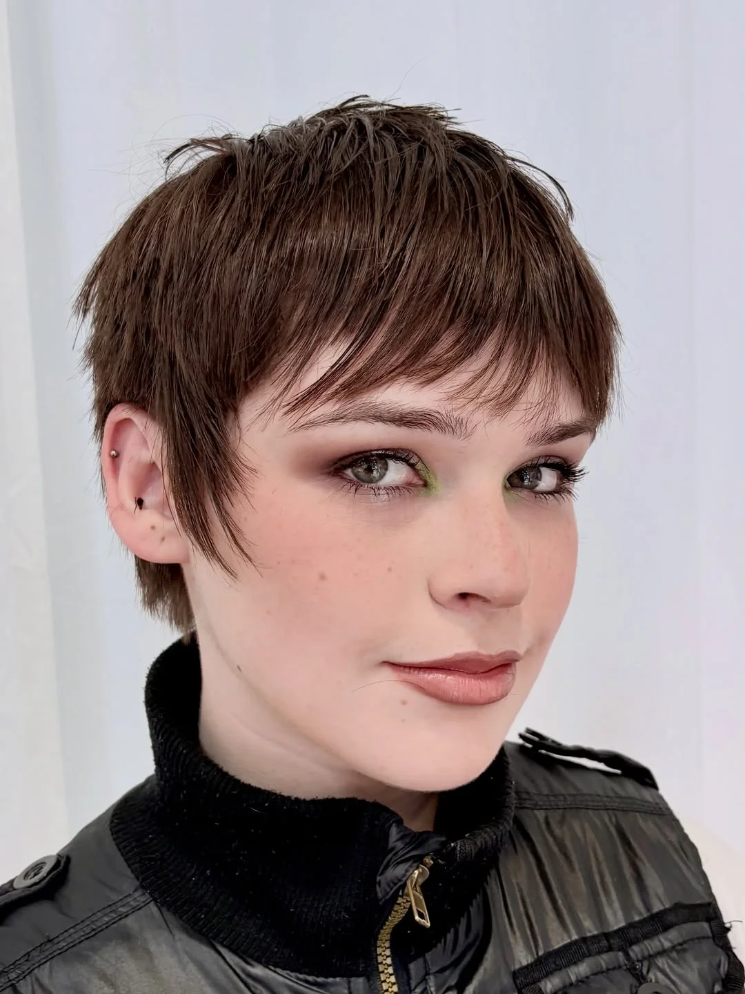 textured summer pixie haircuts 2026 Feathered Brunette Pixie with Light Layers