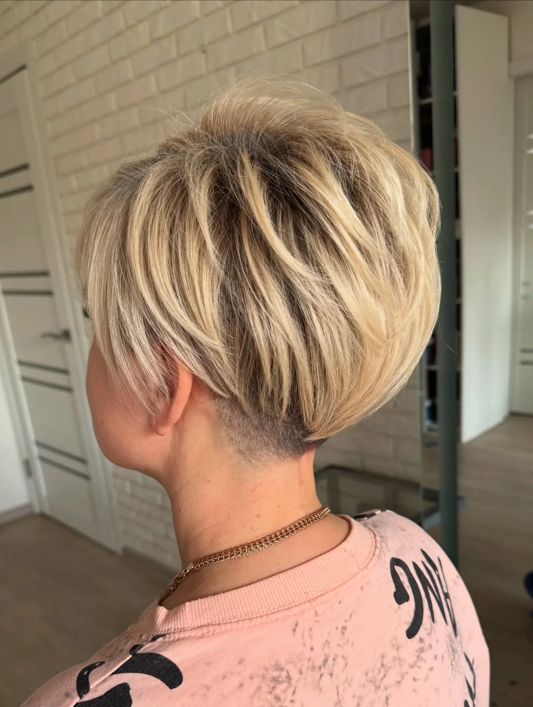 youthful summer haircuts for women over 40 2026 Soft Undercut Pixie with Lifted Blonde Dimension