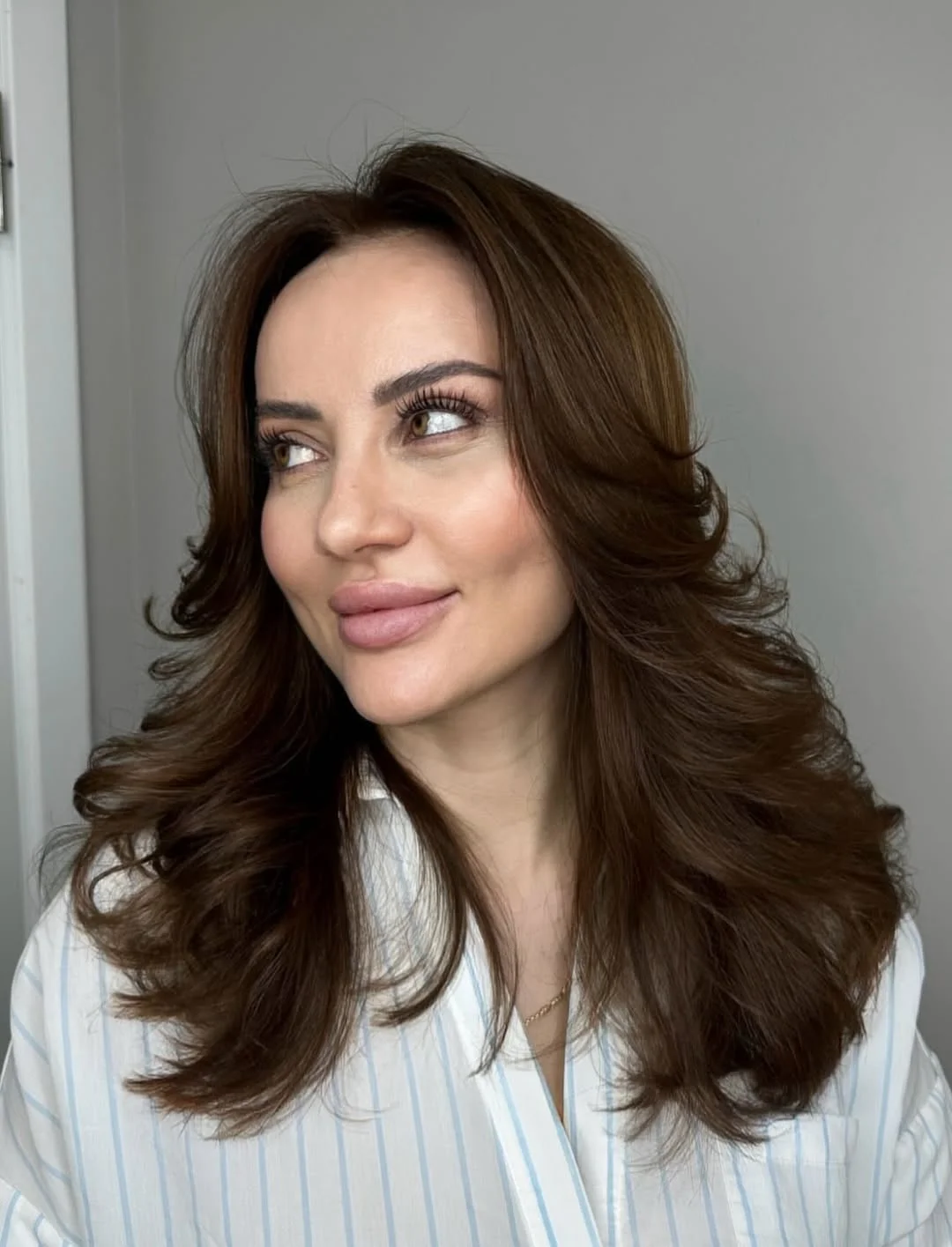 youthful summer haircuts for women over 40 2026 Soft Voluminous Layers with Face-Framing Movement