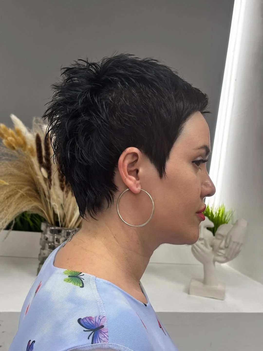 youthful summer haircuts for women over 40 2026 Dark Textured Pixie with Soft Edges