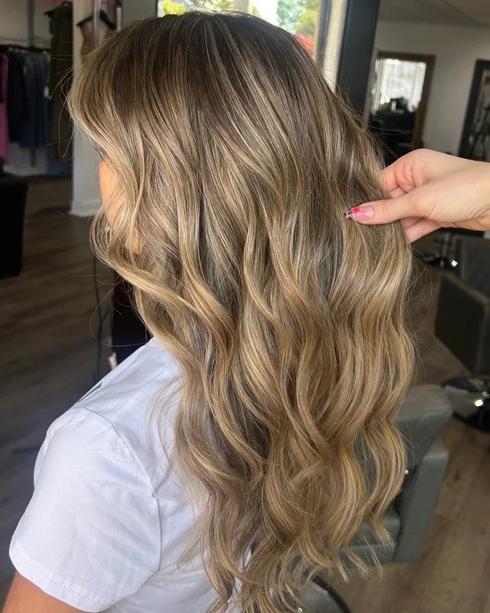 golden summer honey brown hair color 2026 Soft Caramel Balayage with Beachy Movement
