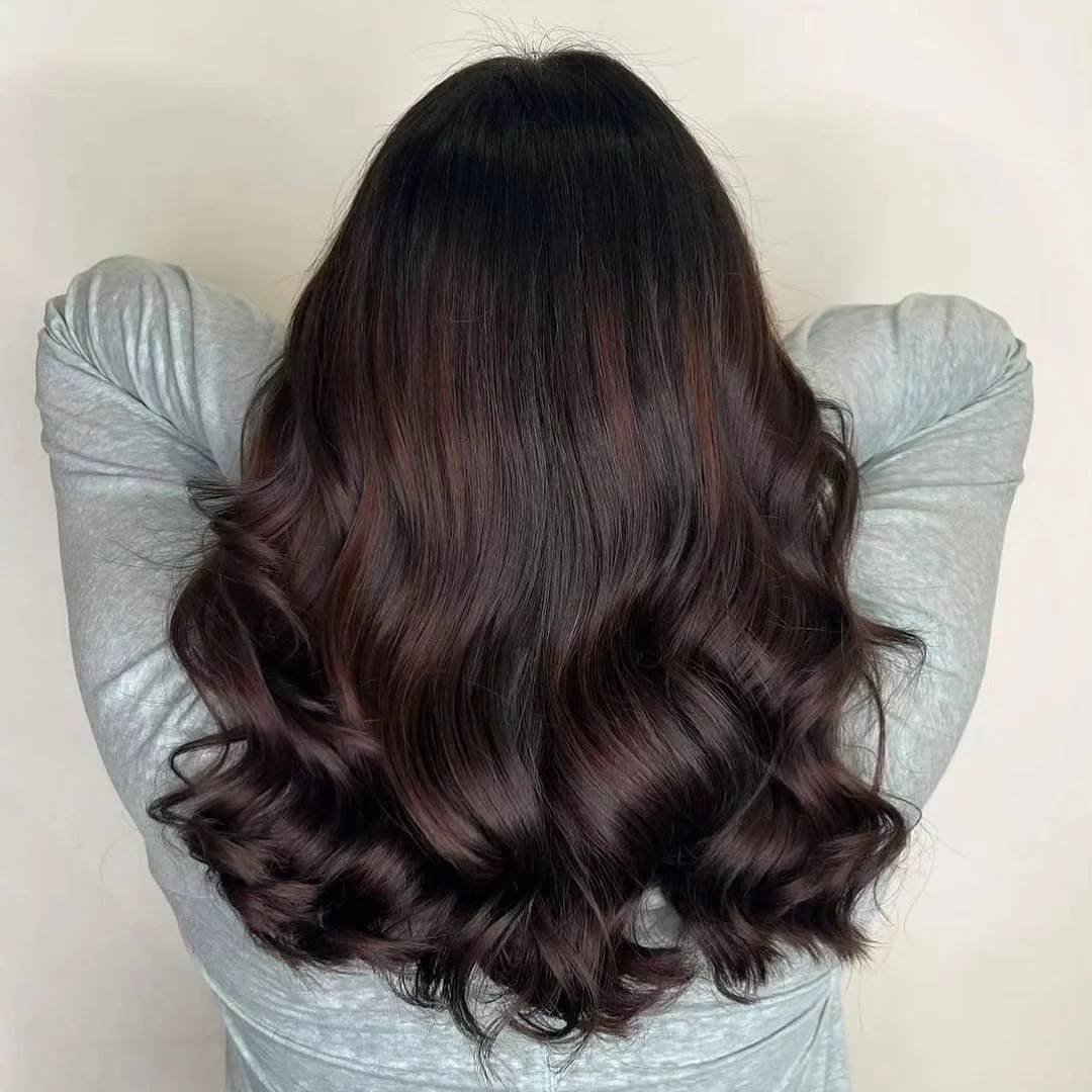 low maintenance summer hair color for brunettes 2026 Glossy Espresso Waves with Deep Red Undertones