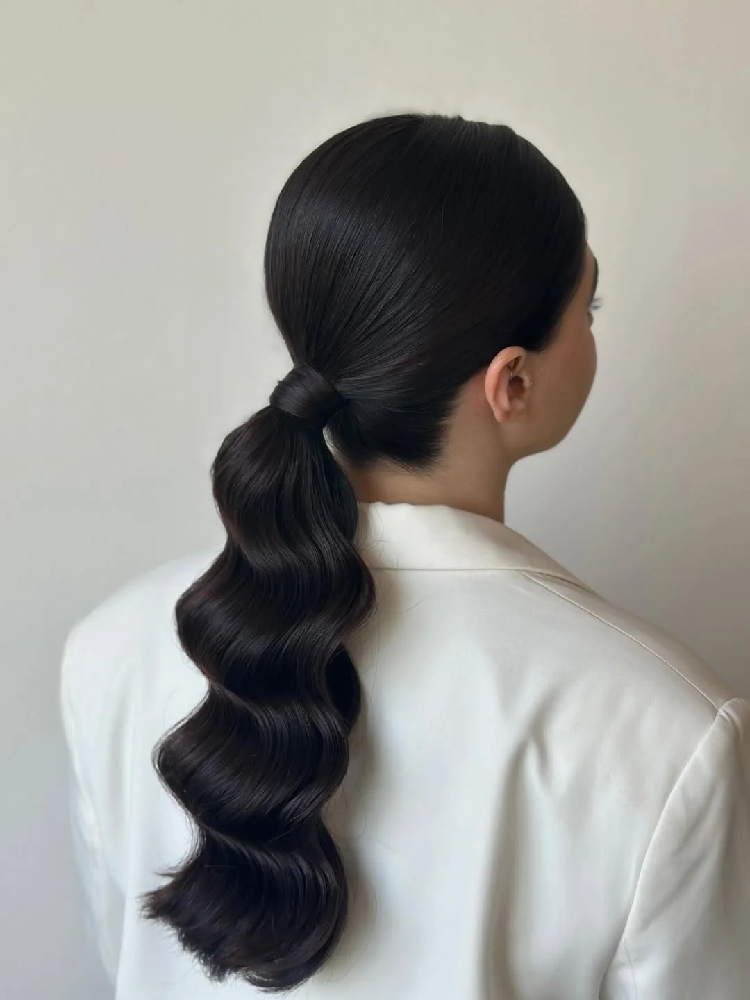 low summer ponytail hairstyle 2026 Dark Glossy Ponytail With Sculpted Waves