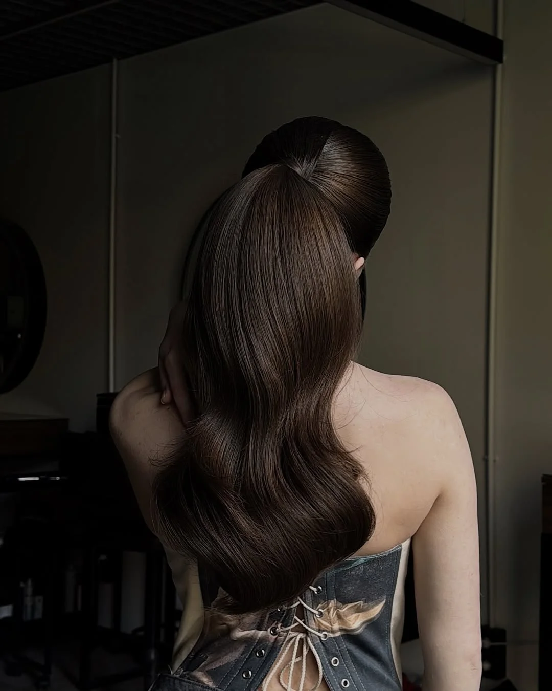 low summer ponytail hairstyle 2026 Dark Hollywood Ponytail With Soft Waves