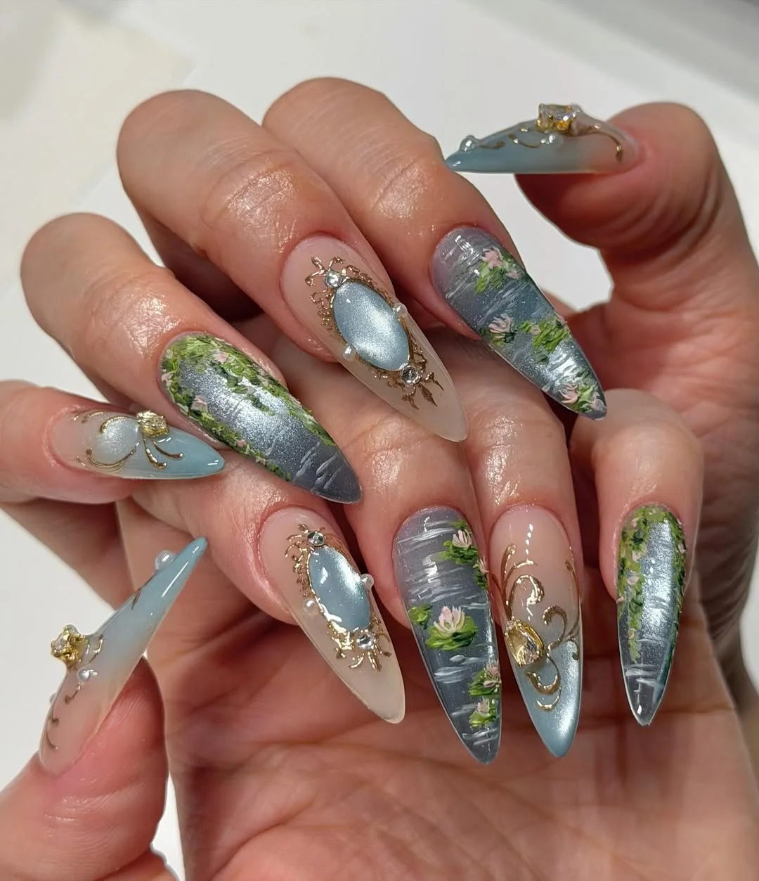 pretty summer almond nails 2026 Soft Blue Botanical Nails With Vintage Garden Charm