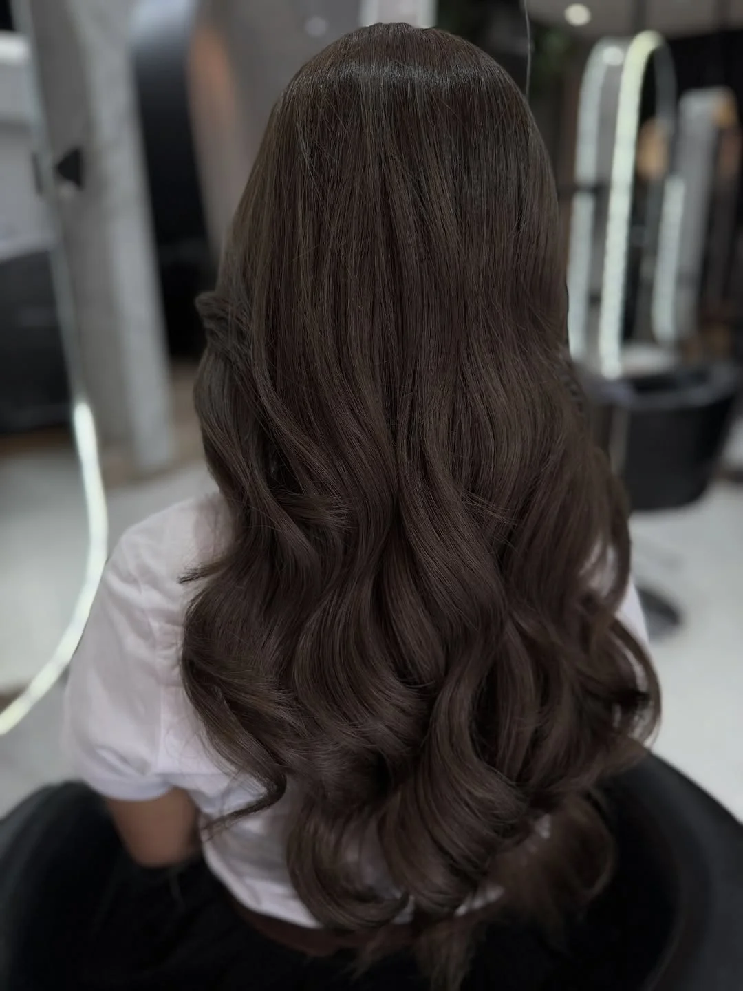 smoky summer ash brown hair color 2026 Glossy mocha waves with soft smoky depth