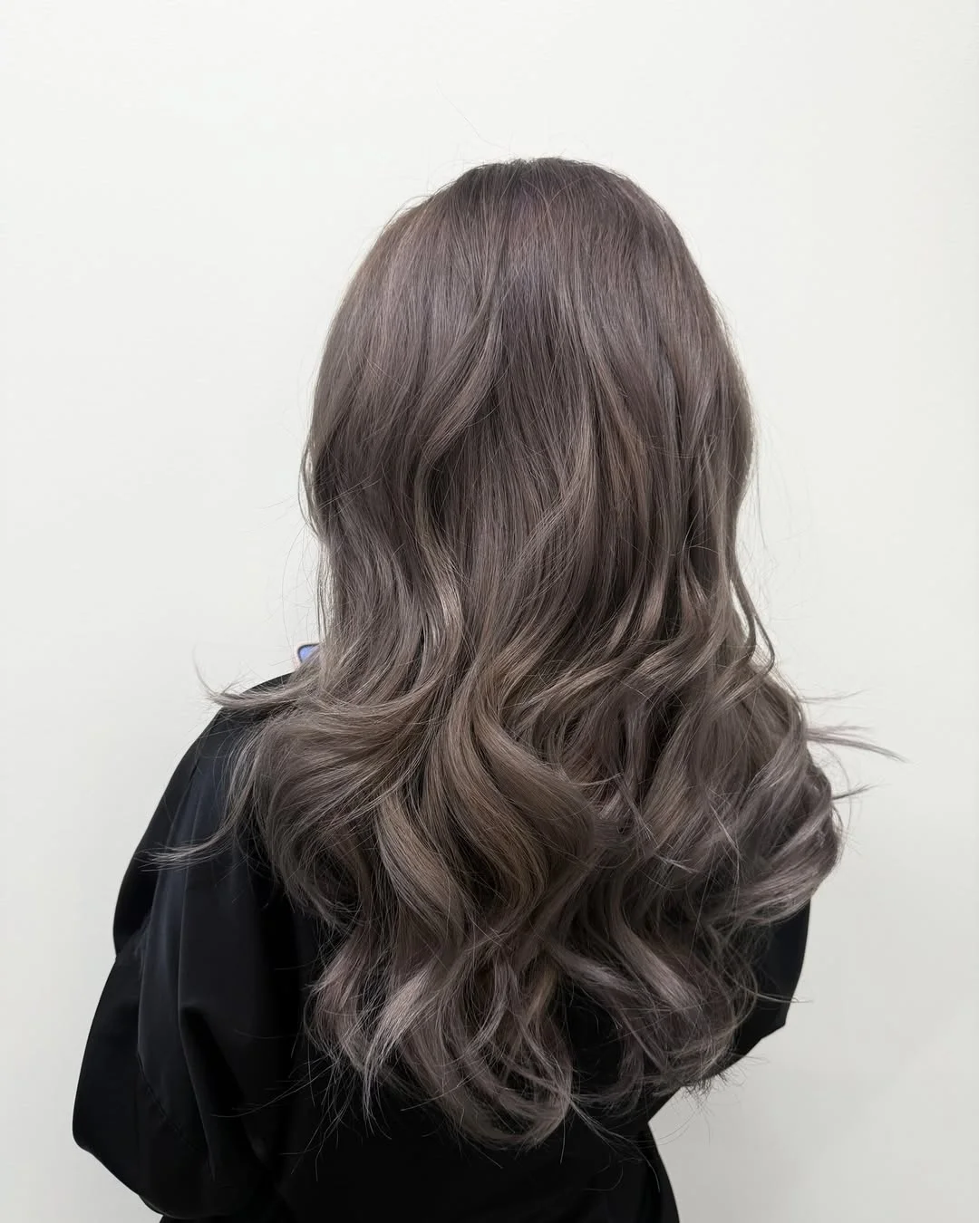 smoky summer ash brown hair color 2026 Muted smoky waves with cool toned softness