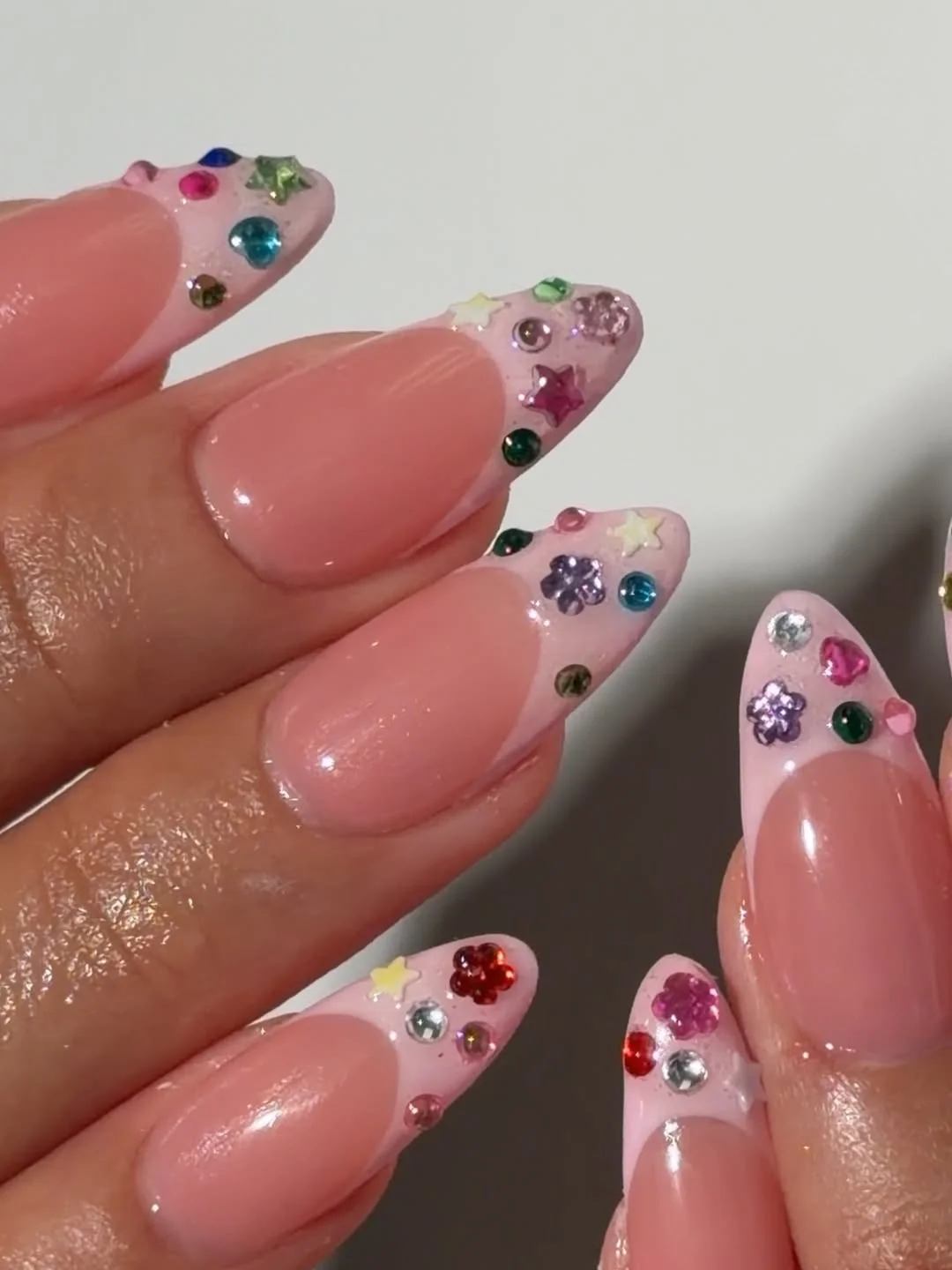 Summer French nails ideas 2026 Pink French Nails With Colorful Gemstone Tips