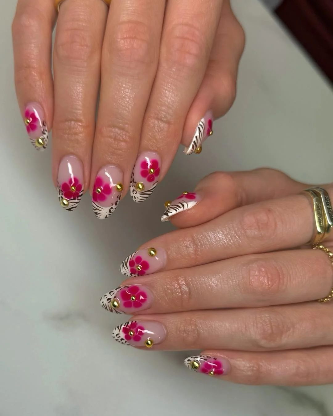 Summer nail art ideas 2026 Pink Tropical Flower Nails with Gold Stud Details