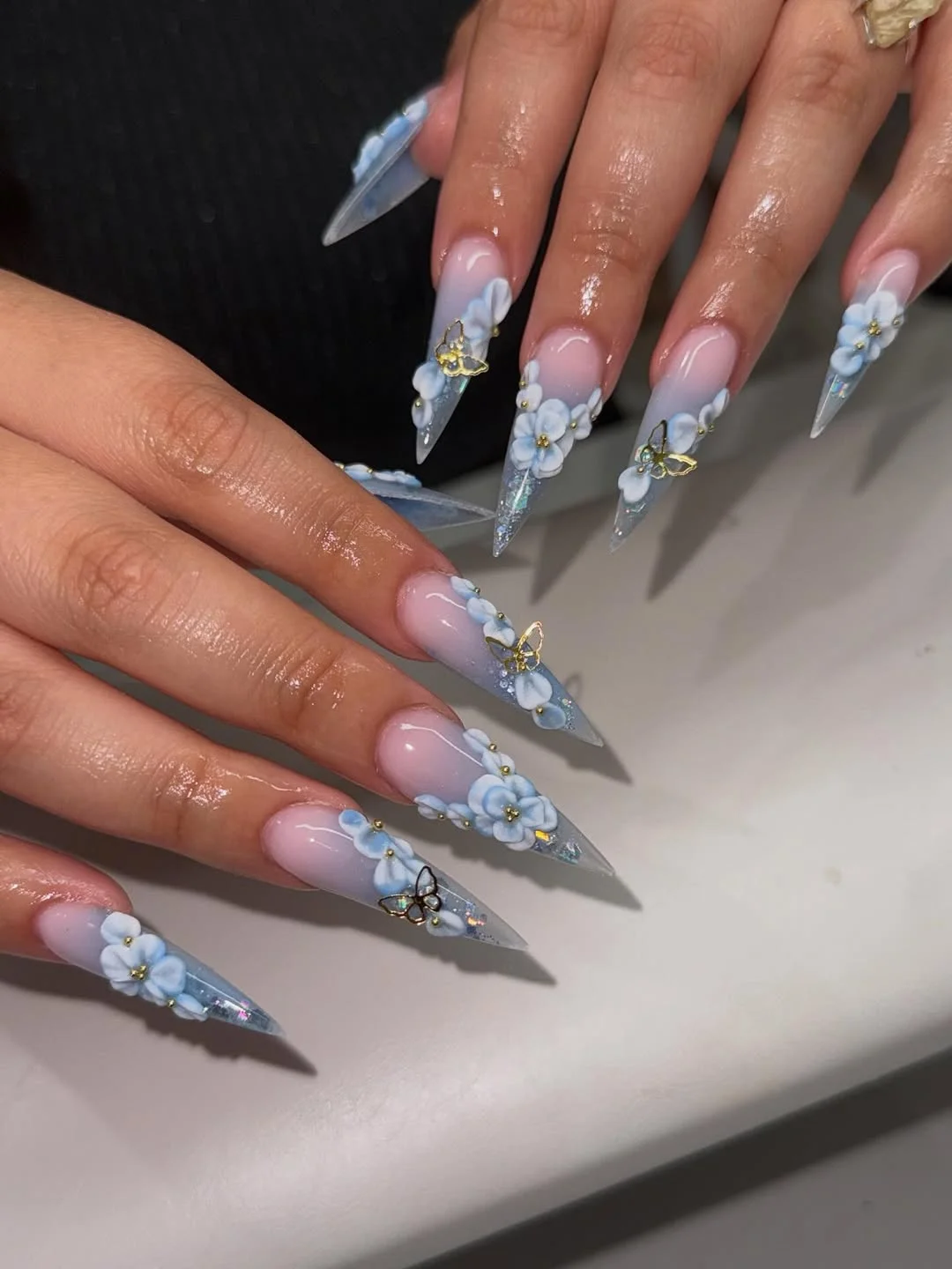 summer ombre nails 2026 Soft Blue Floral Ombre Nails With Butterfly Accents