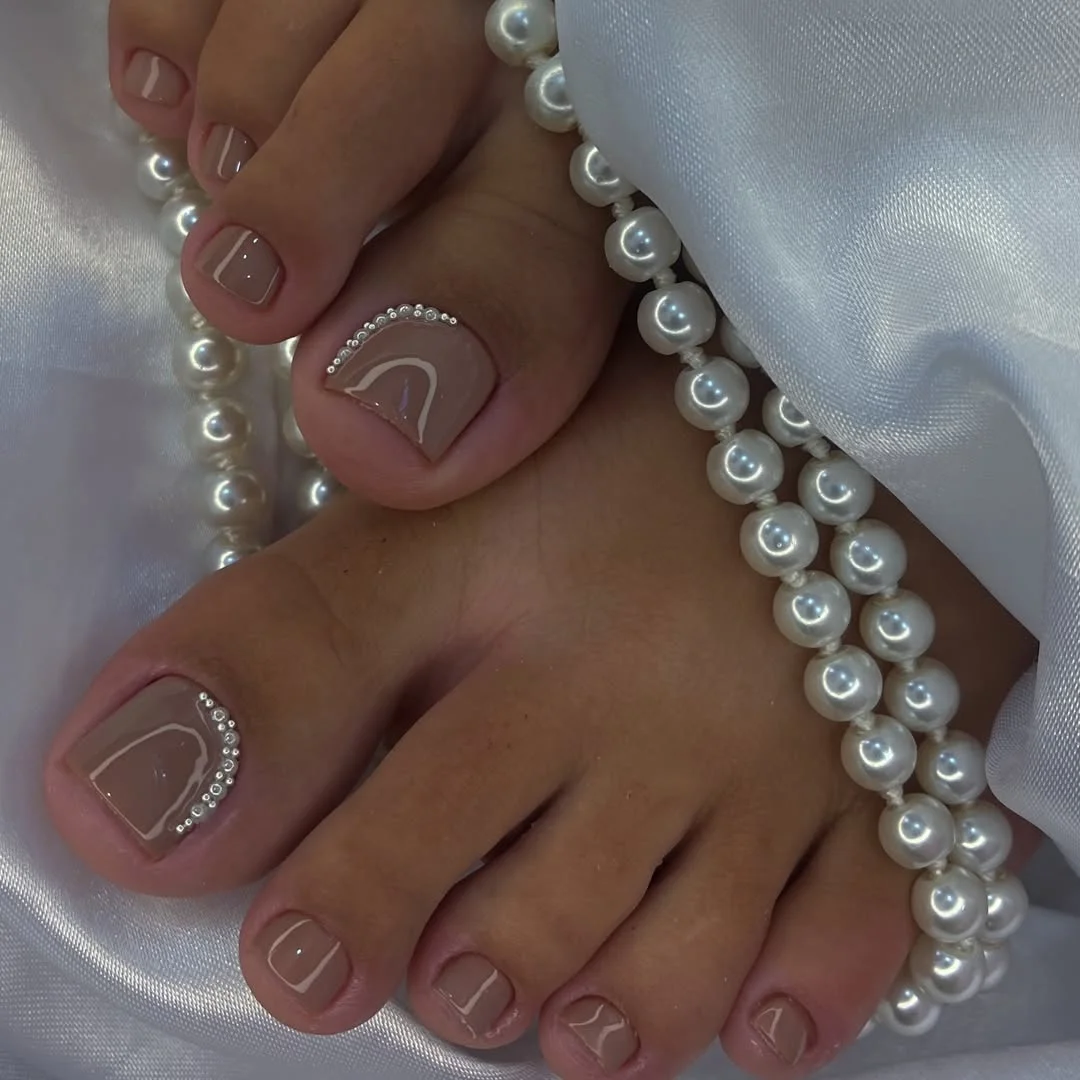 summer pedicure colors 2026 Neutral Nude Pedicure With Pearl Details