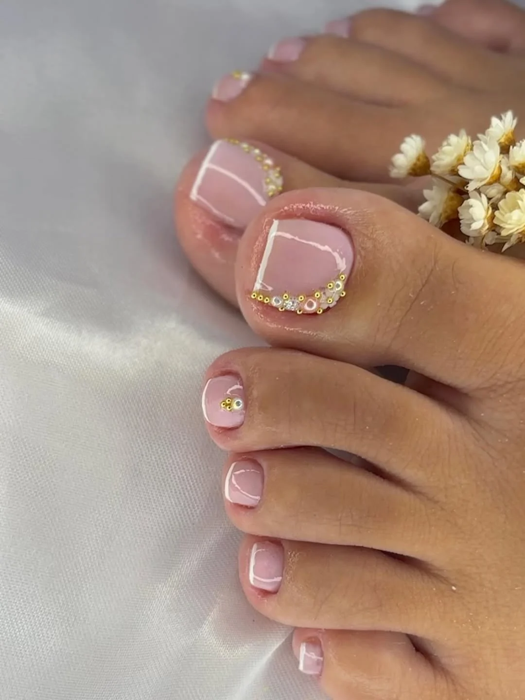 summer toe nails colors 2026 Glossy Pink Pedicure With Minimal Gold Details