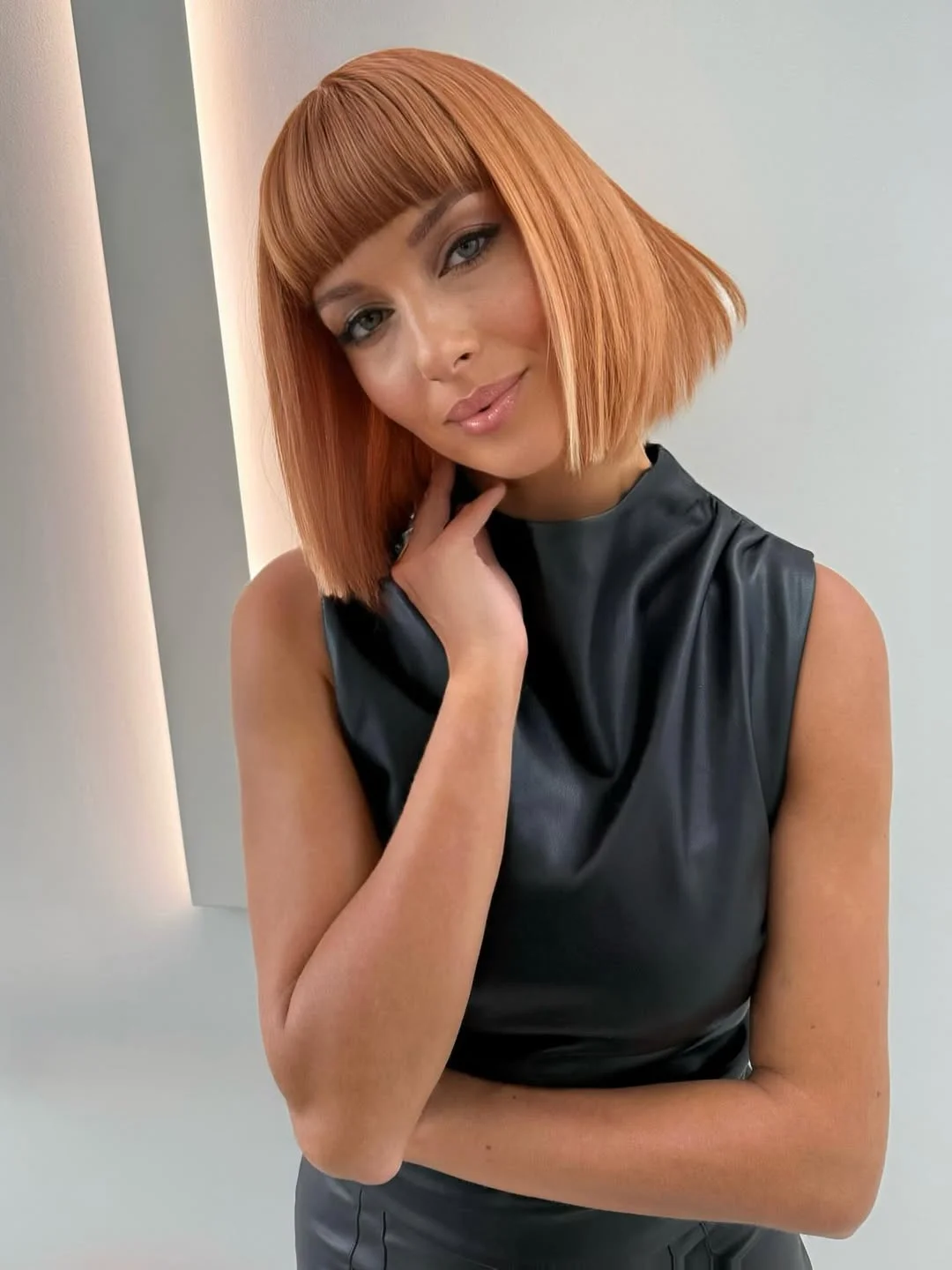 warm summer hair color for tan skin 2026 Sharp Copper Bob with Graphic Edge