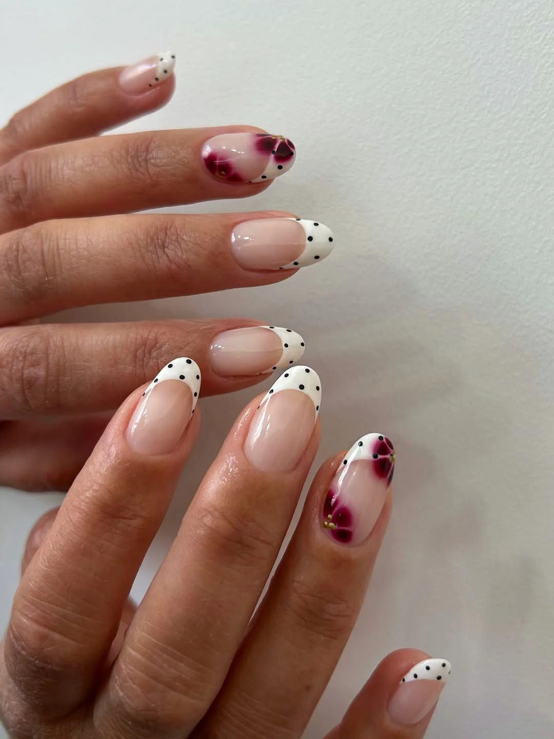 cool july nail colours ideas 2026 Polka Dot French With Berry Bloom Accents