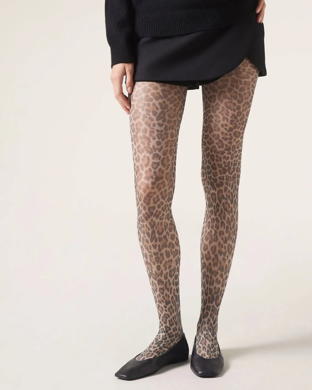 cute fall outfits with tights 2026 Leopard Print Tights That Turn a Simple Mini Into a Statement
