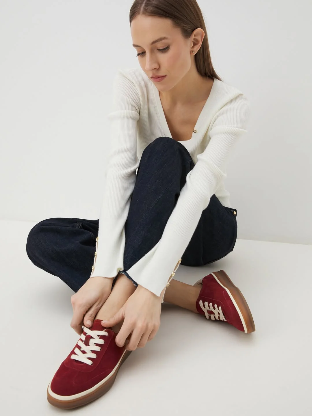 fall travel outfits with sneakers 2026 Burgundy Sneakers and Dark Denim Essentials
