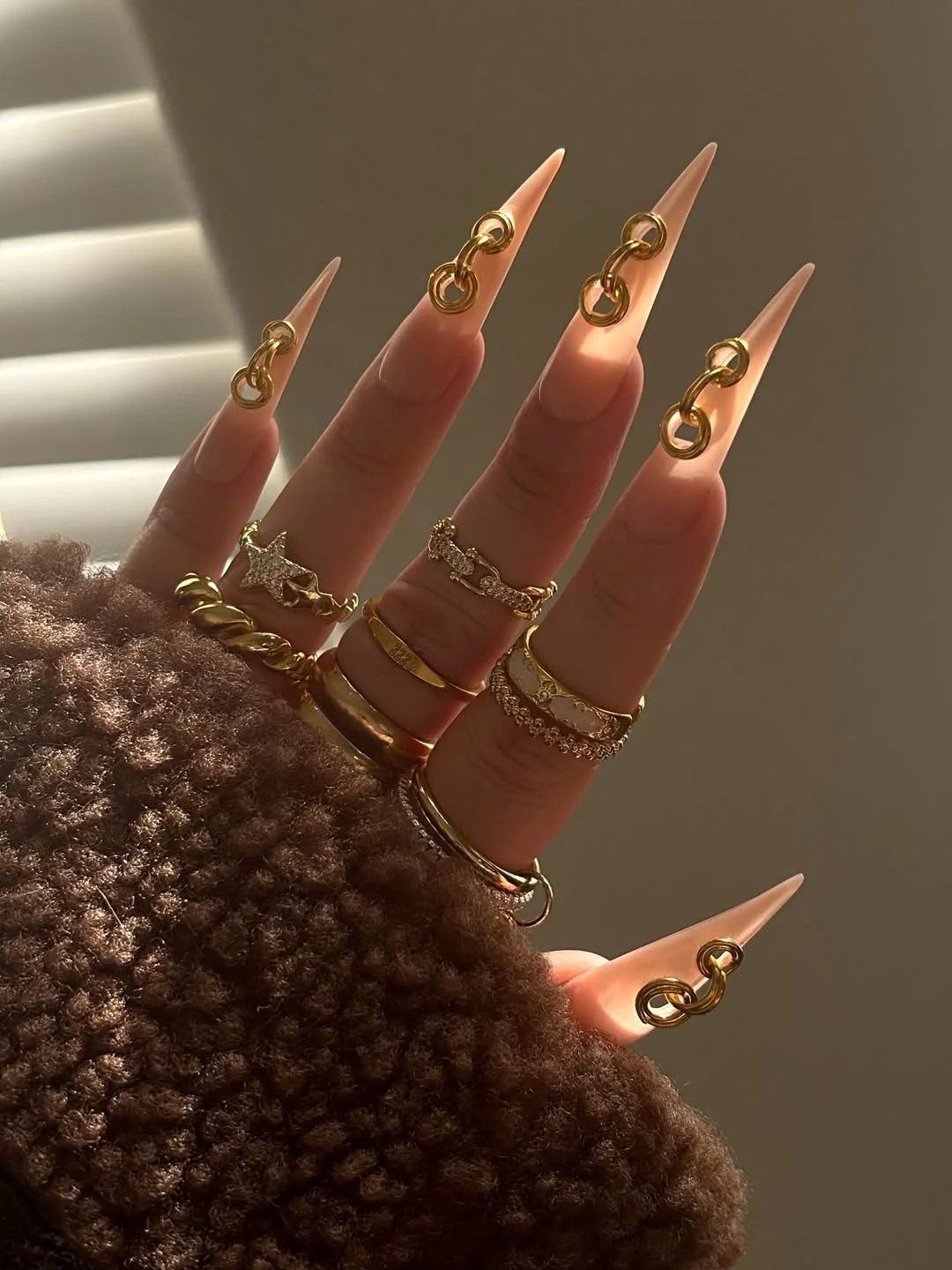 modern june manicure ideas 2026 Minimal Nude Stiletto Nails with Gold Hardware