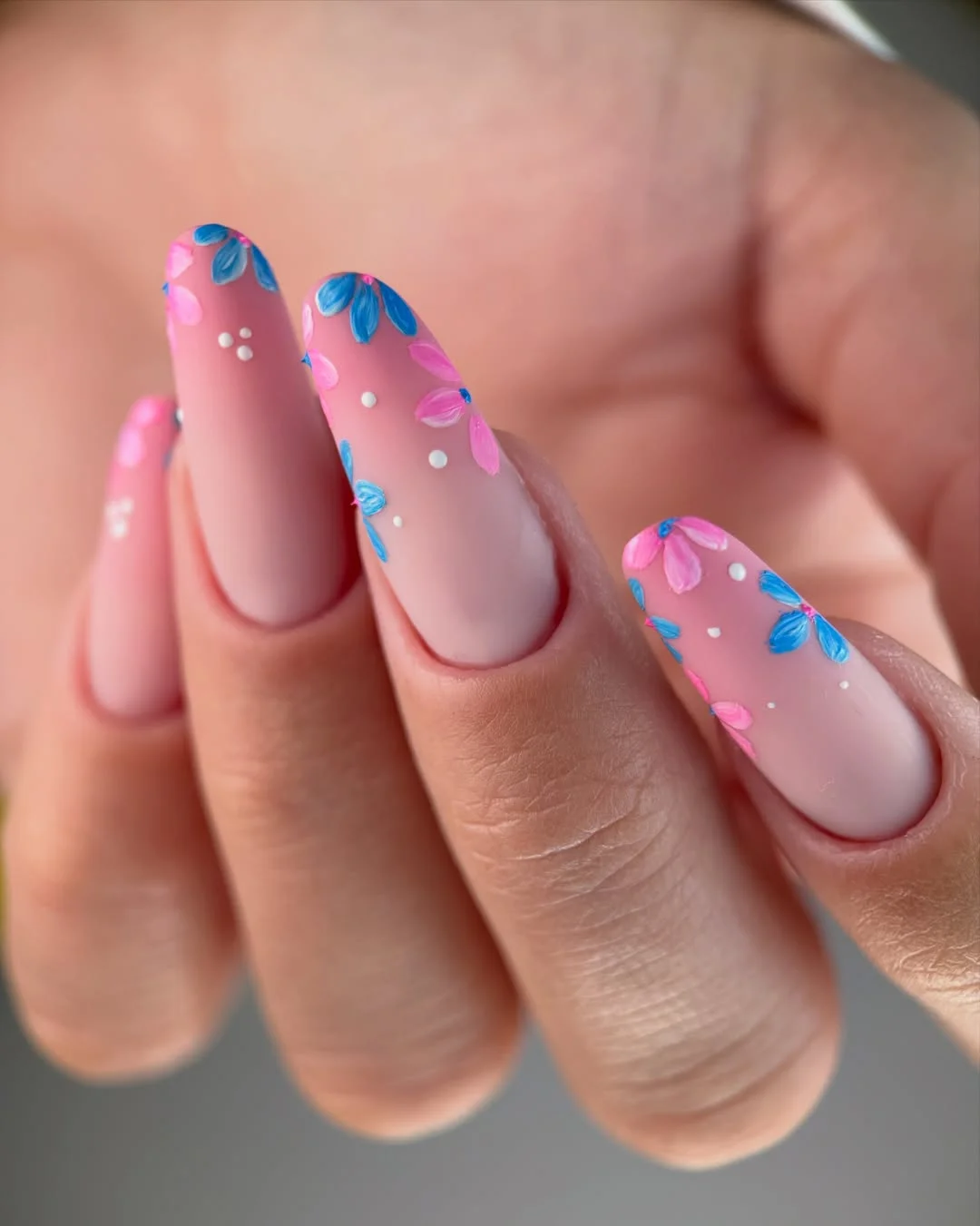 modern june manicure ideas 2026 Soft Pink Floral Nails With Blue Petal Details