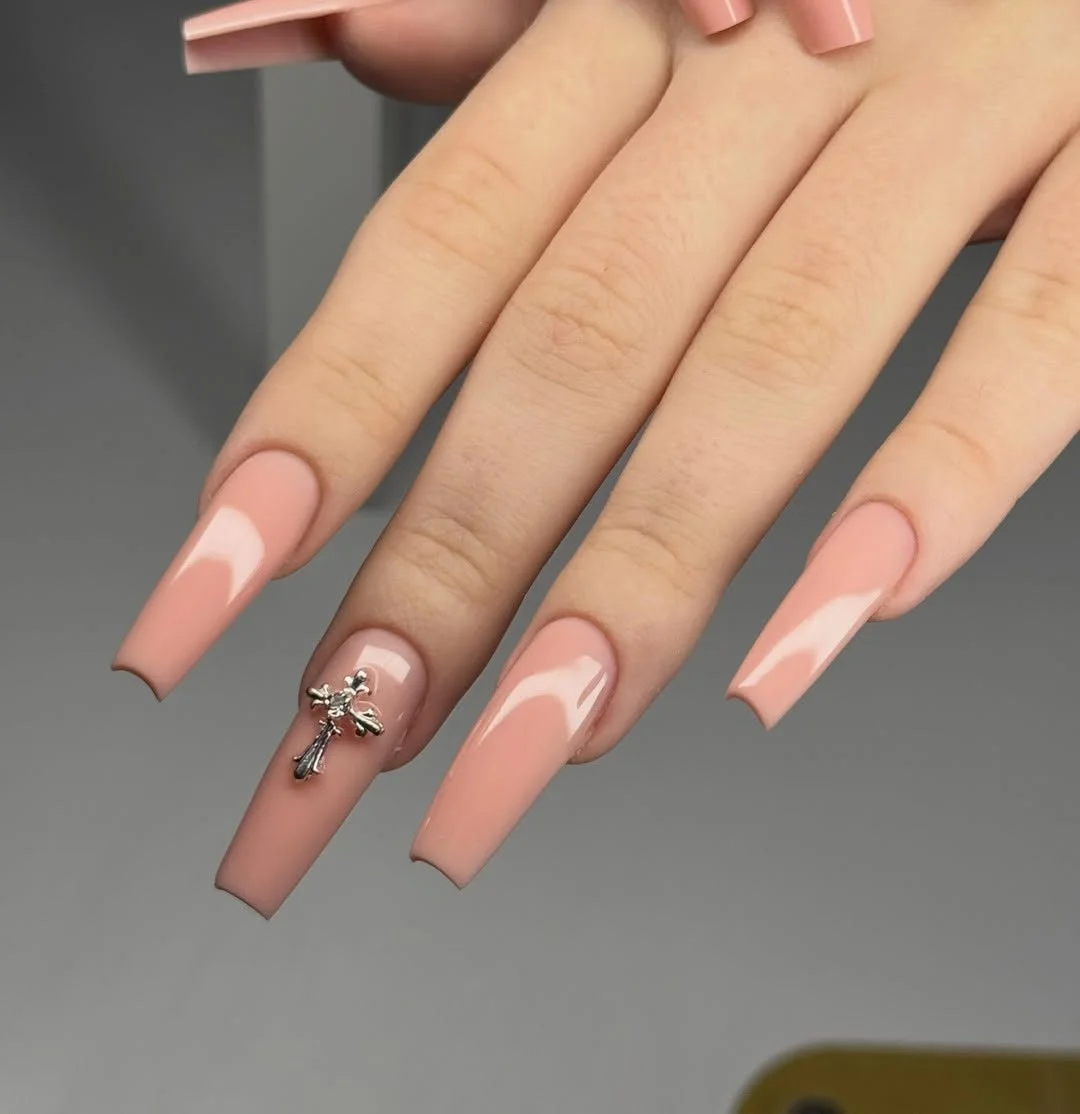 modern june manicure ideas 2026 Glossy Nude Coffin Nails With Silver Charm Accent