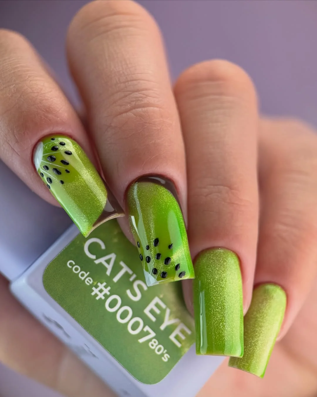 modern june manicure ideas 2026 Fresh Kiwi Green Nails with Cat Eye Shine