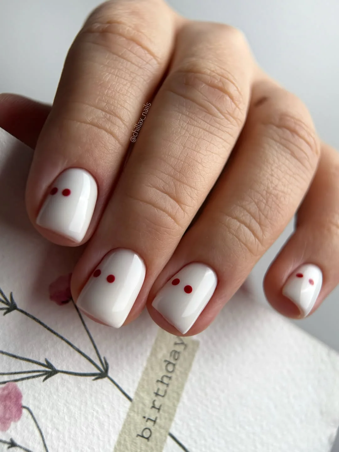 pretty july nails design ideas 2026 Minimal White Nails with Tiny Cherry Red Accents