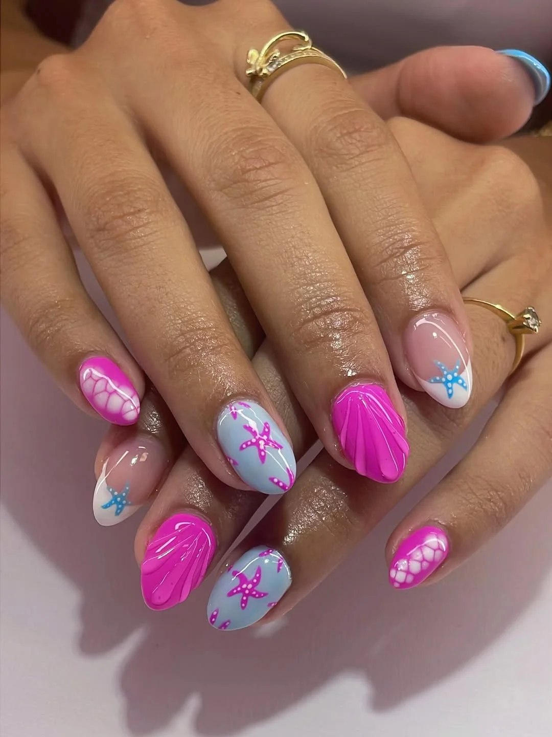 pretty starfish summer nails 2026 Bright Pink Beach Nails With Playful Starfish Art