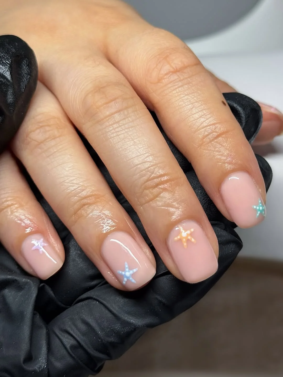 pretty starfish summer nails 2026 Short Nude Nails With Tiny Colorful Starfish