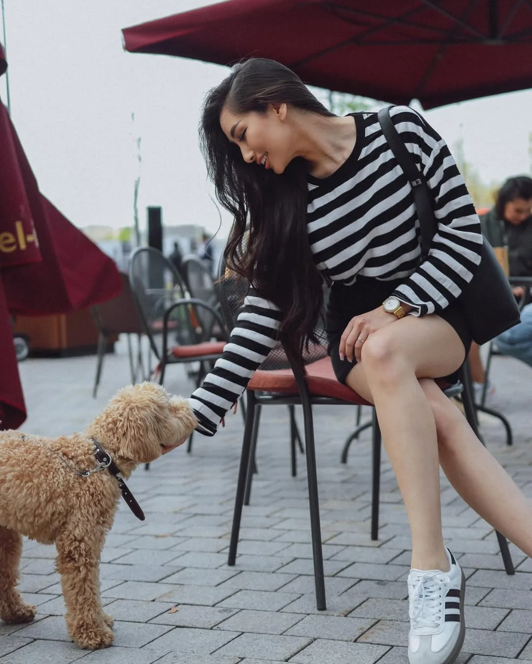 trendy fall skirt and sneakers outfits 2026 Striped Sweater and Black Mini Skirt Combo