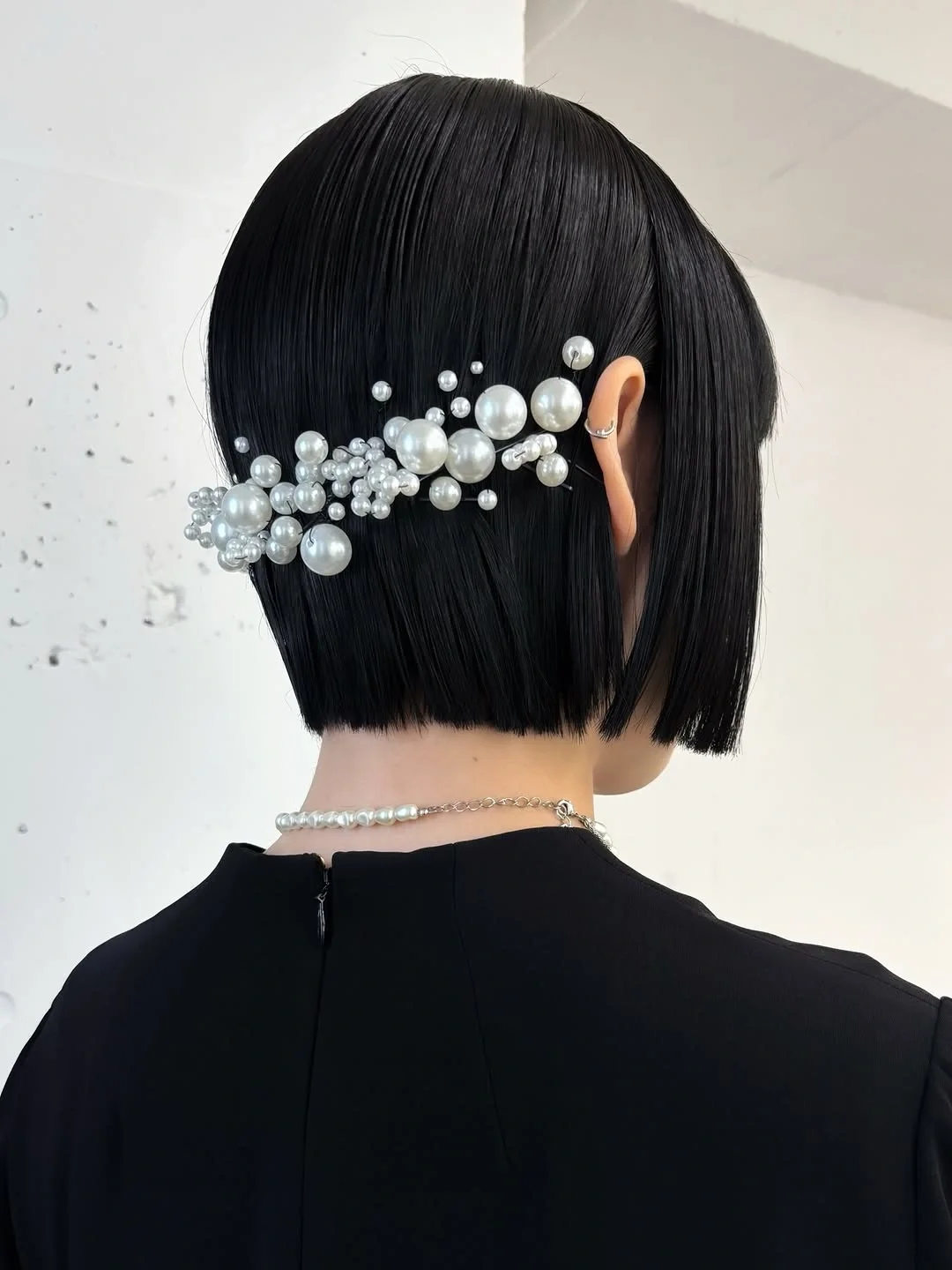 august hairstyles and color ideas 2026 Glossy Black Bob with Pearl Details