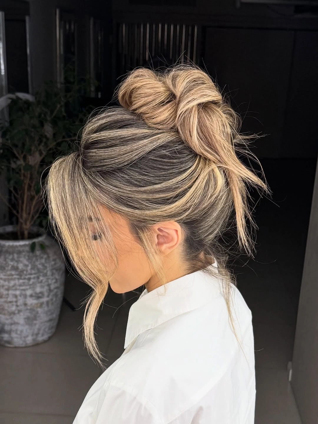 beautiful september hairstyles ideas 2026 Relaxed Textured Bun With Soft Blonde Face-Framing Layers