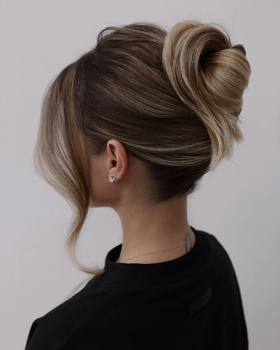 beautiful september hairstyles ideas 2026 Minimalist Twisted Bun with Sleek Blonde Dimension