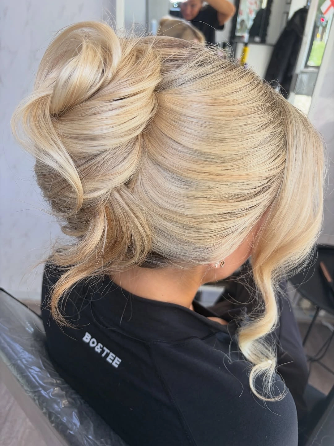 fall hairstyles for long hair 2026 Soft Sculptural Low Bun With Face-Framing Tendrils