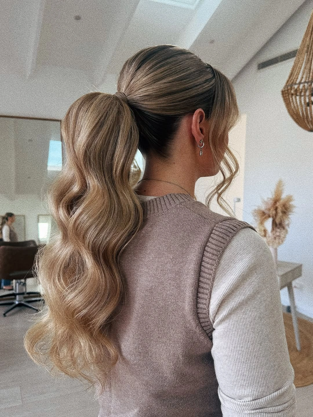 fall hairstyles for wedding guests 2026 Voluminous Low Ponytail With Soft Waves