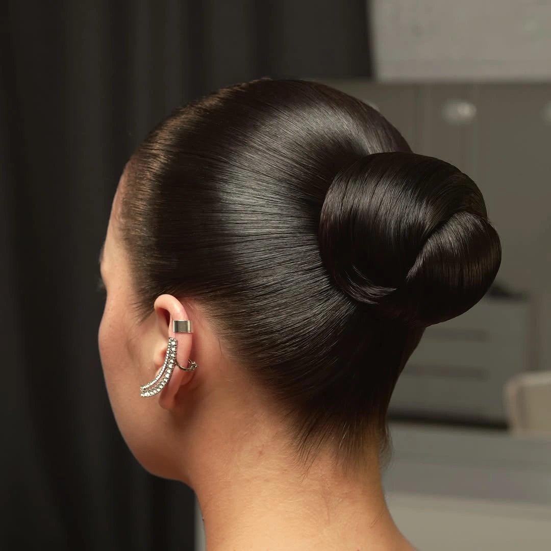 fall hairstyles for wedding guests 2026 Sleek High Bun With Timeless Sophistication