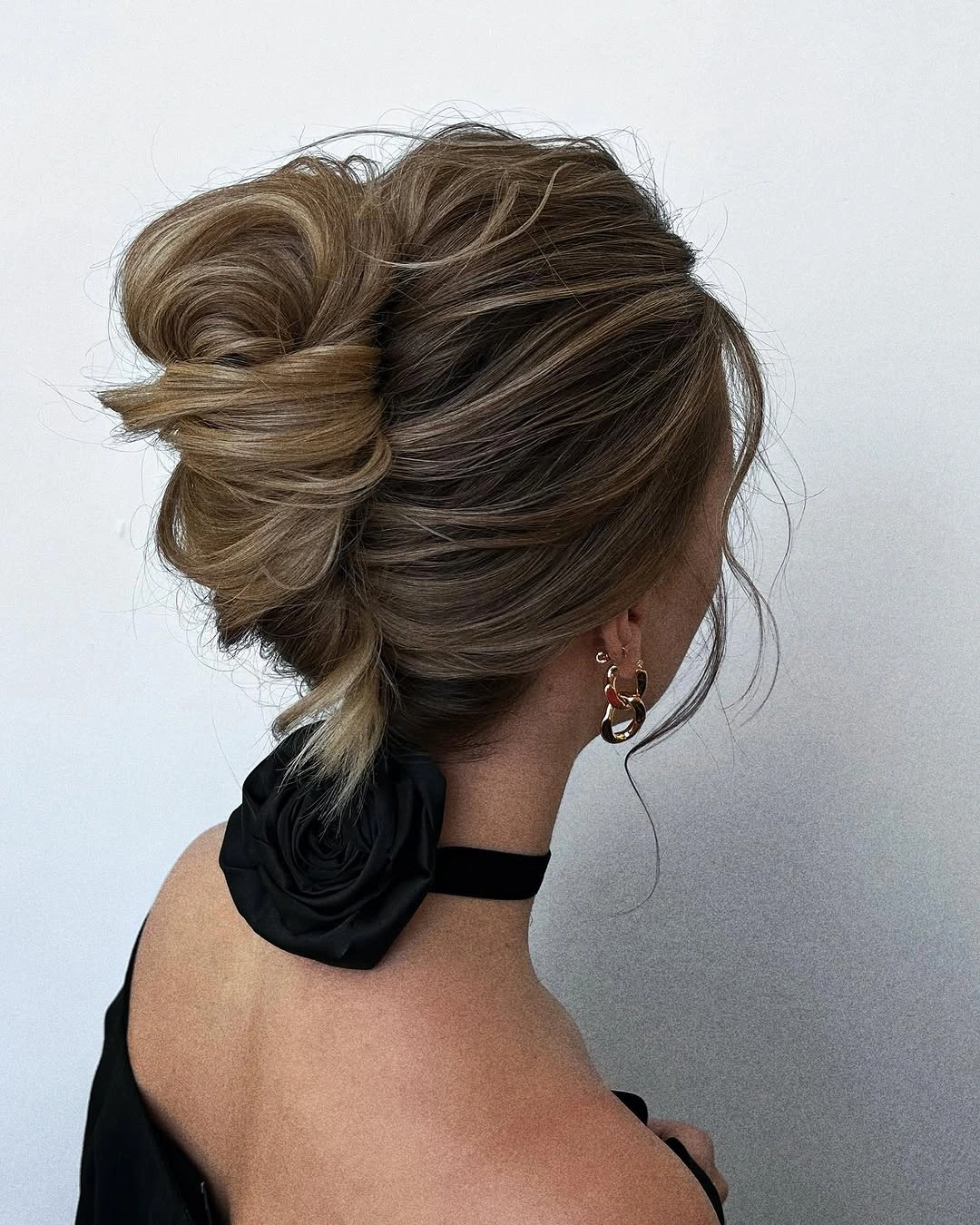 fall hairstyles for wedding guests 2026 Relaxed Twisted Bun With Modern Texture