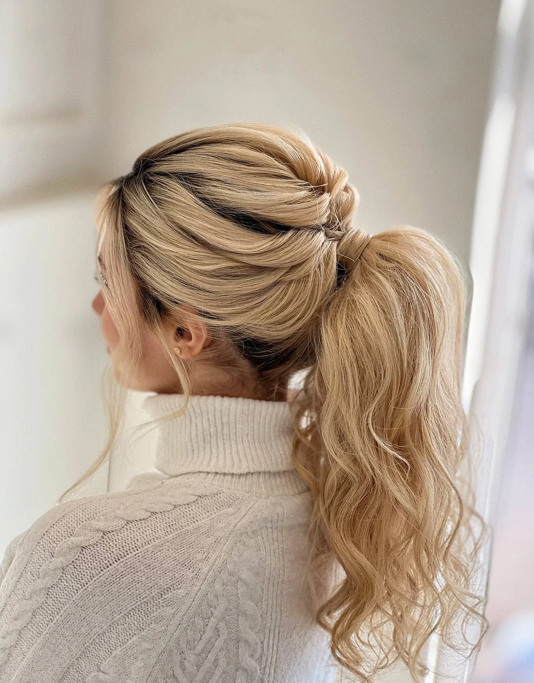 fall hairstyles for wedding guests 2026 Voluminous Wrapped Ponytail With Soft Waves