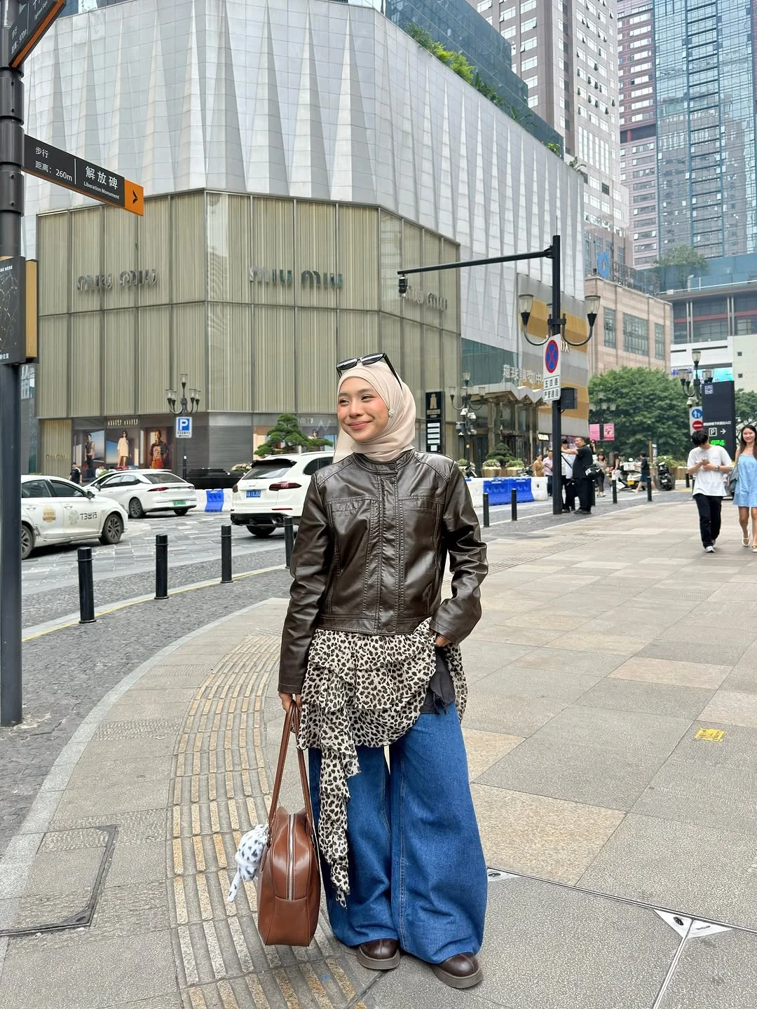 leather jacket outfits women 2026 Brown Leather Jacket Styled With Wide Denim and a Hijab